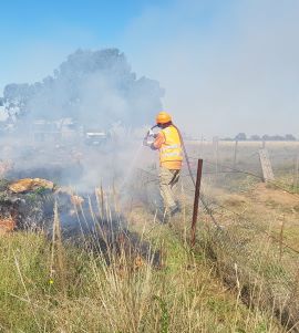 MCMC staff member, conducting an ecological burn at a Metro Train site